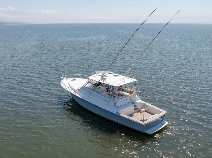 Alexa Corinne Yacht Photos Pics 1999 Ocean Yachts 48 Express boat on calm water, aerial view.