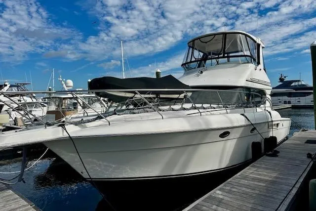  Yacht Photos Pics 2001 Silverton 42 Convertible yacht docked under a blue sky.
