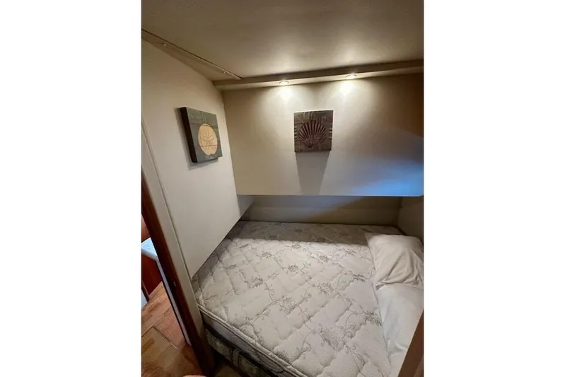  Yacht Photos Pics 2001 Silverton 42 Convertible cabin interior with bed and wall art.