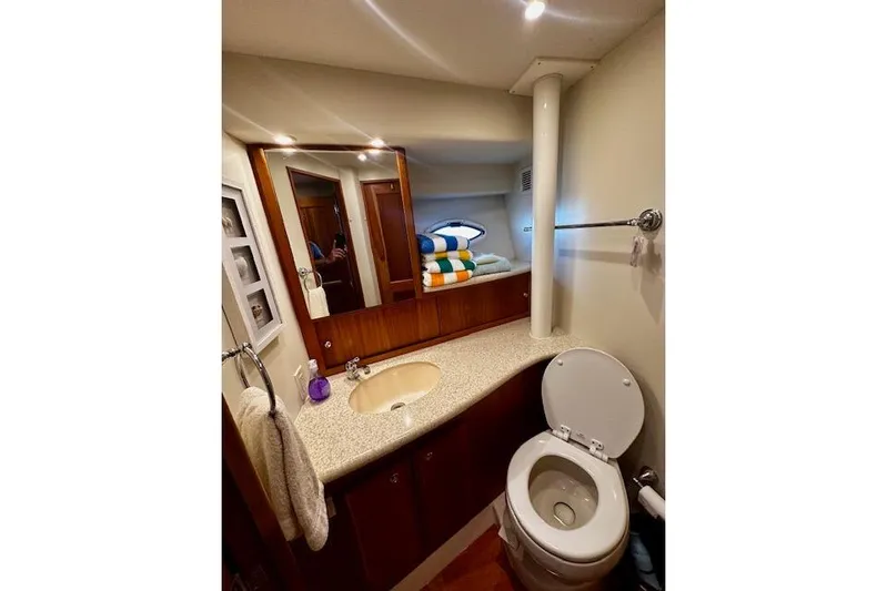  Yacht Photos Pics Bathroom interior of 2001 Silverton 42 Convertible yacht, featuring sink and toilet.