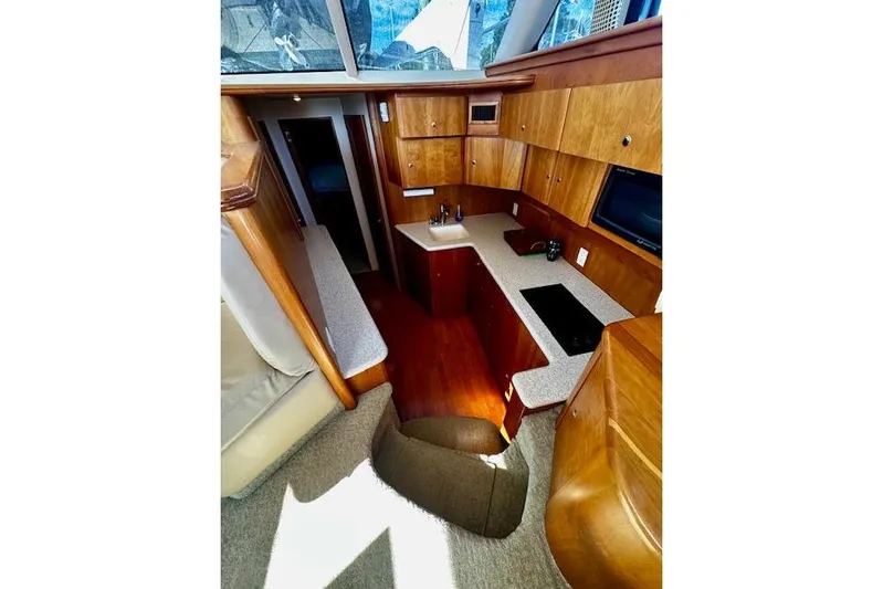 Yacht Photos Pics Interior of 2001 Silverton 42 Convertible yacht with modern kitchen and wood cabinetry.