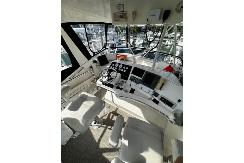  Yacht Photos Pics 2001 Silverton 42 Convertible yacht helm with navigation instruments and seating.
