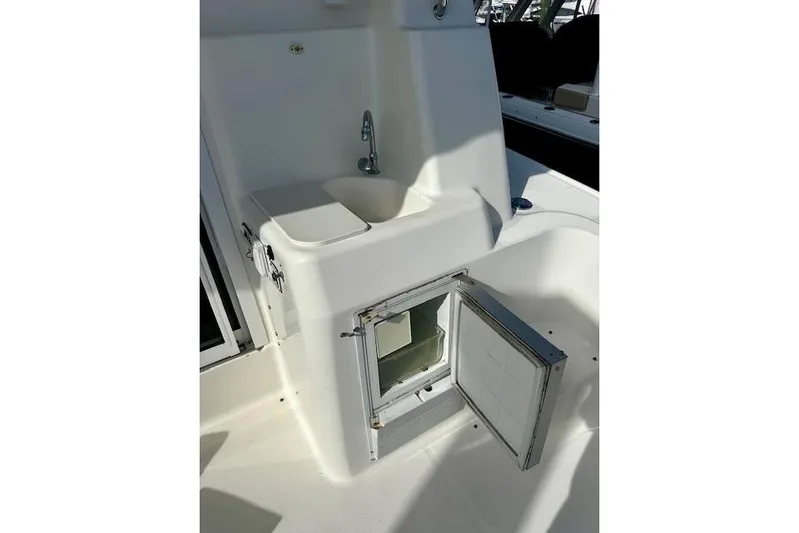  Yacht Photos Pics 2001 Silverton 42 Convertible boat sink and storage area with open compartment.