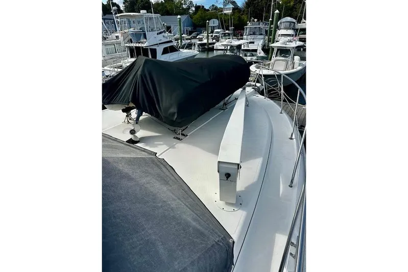  Yacht Photos Pics 2001 Silverton 42 Convertible yacht docked at marina, covered deck, surrounded by boats.