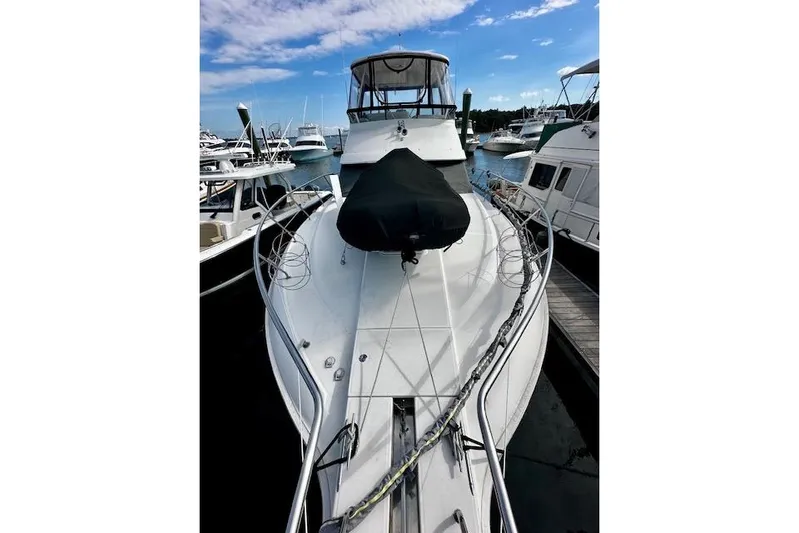  Yacht Photos Pics 2001 Silverton 42 Convertible yacht docked at marina under blue sky.