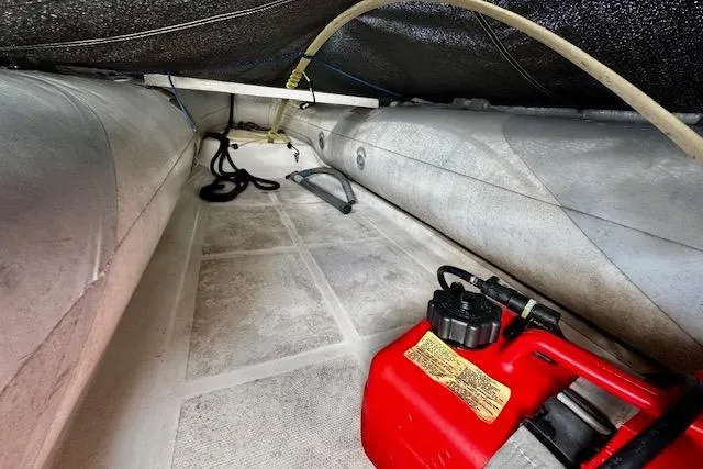  Yacht Photos Pics 2001 Silverton 42 Convertible boat interior with red fuel container and storage space.