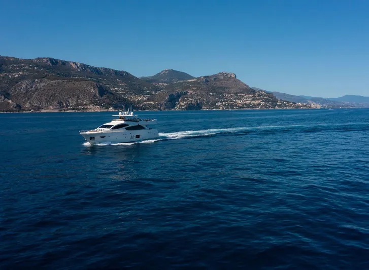 Grace Yacht Photos Pics Luxury yacht Astondoa 96 GLX cruising on blue ocean near scenic coastline, 2009 model.