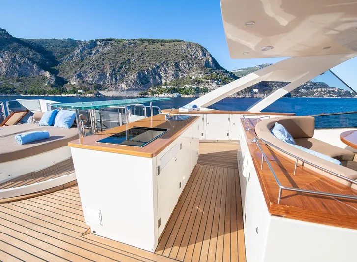 Grace Yacht Photos Pics Luxurious deck of 2009 Astondoa 96 GLX yacht with scenic coastal backdrop.