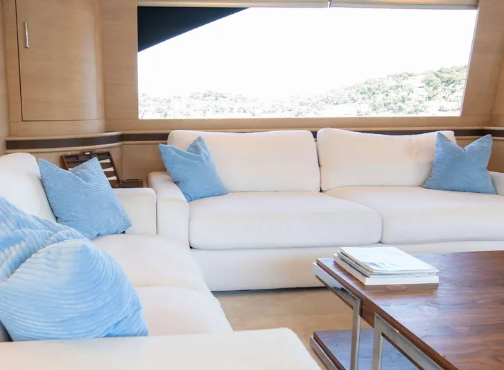 Grace Yacht Photos Pics Luxurious interior of 2009 Astondoa 96 GLX yacht with white sofas and blue cushions.