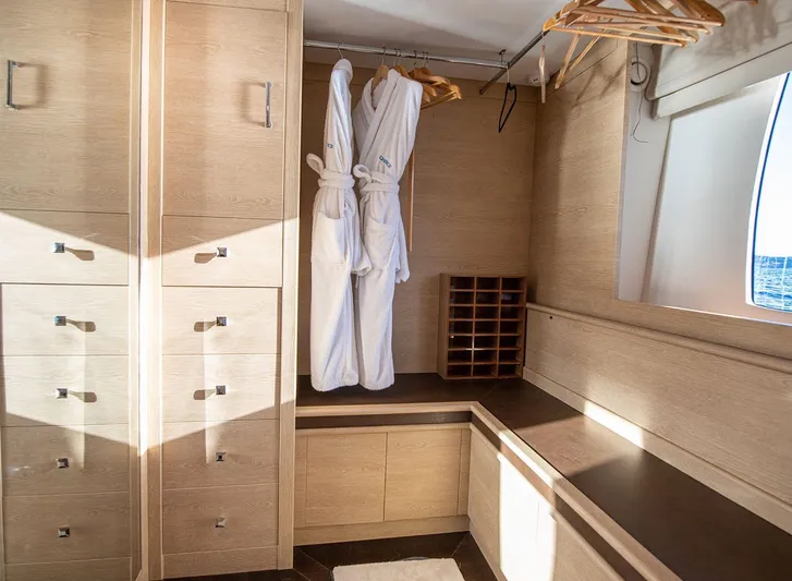 Grace Yacht Photos Pics Luxurious wooden closet interior on 2009 Astondoa 96 GLX yacht with robes and hangers.