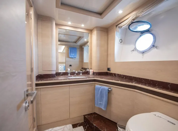 Grace Yacht Photos Pics Luxurious bathroom on 2009 Astondoa 96 GLX yacht with elegant fixtures and porthole window.