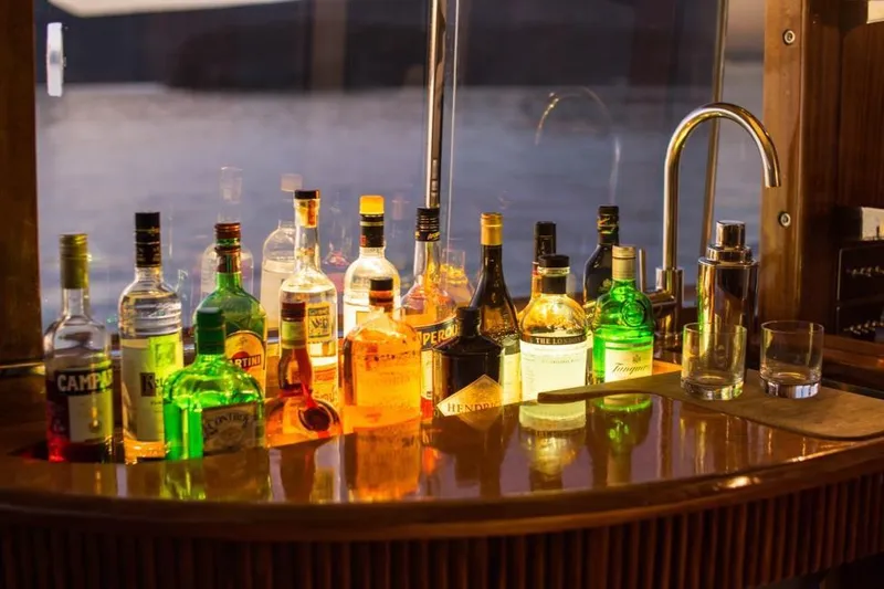 New School Yacht Photos Pics Bar setup on 1966 Chris-Craft 57 Constellation yacht with assorted liquor bottles.