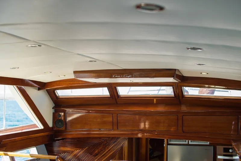 New School Yacht Photos Pics Interior of 1966 Chris-Craft 57 Constellation yacht with polished wood and windows.