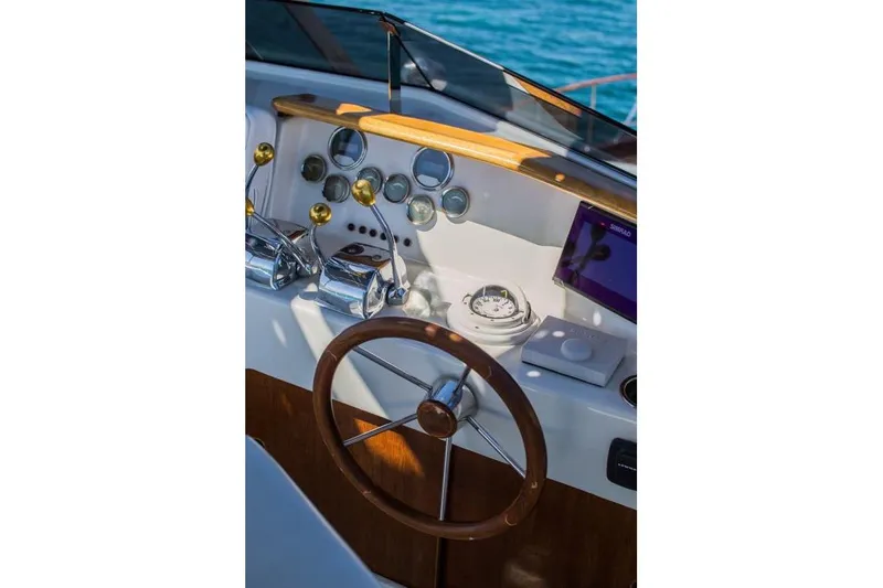 New School Yacht Photos Pics Helm of 1966 Chris-Craft 57 Constellation with wooden wheel and vintage controls.