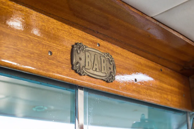 New School Yacht Photos Pics Vintage 1966 Chris-Craft Constellation boat interior with decorative "BAR" sign.