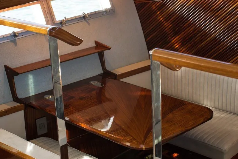 New School Yacht Photos Pics 1966 Chris-Craft Constellation interior with polished wood table and seating.