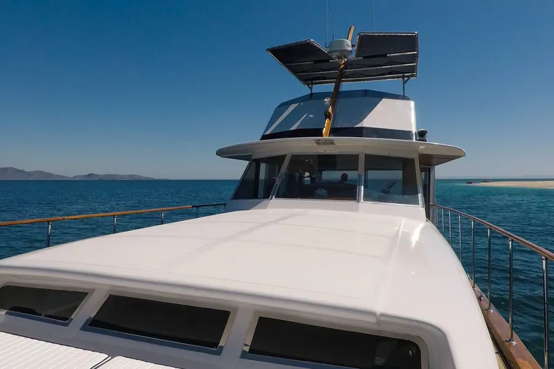 New School Yacht Photos Pics 1966 Chris-Craft Constellation yacht cruising on clear blue waters under a sunny sky.