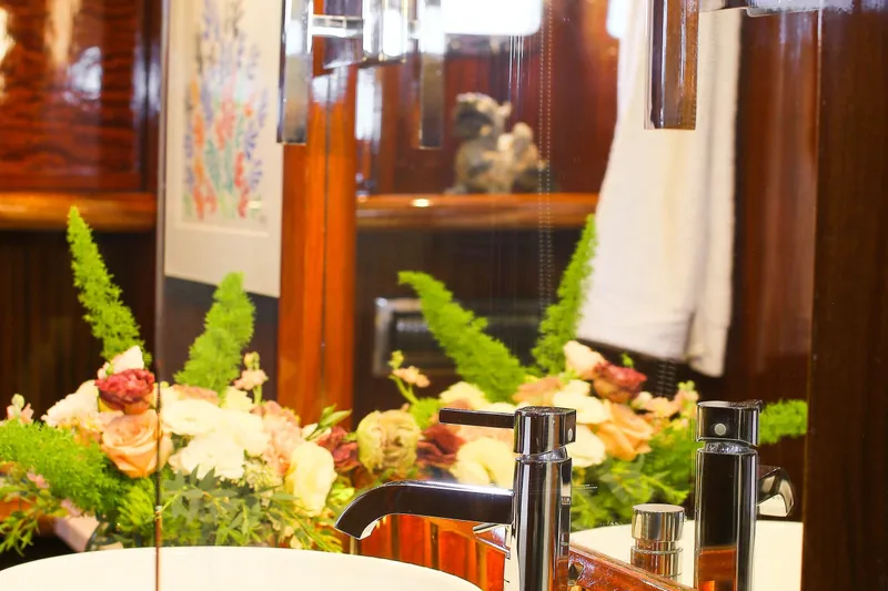 New School Yacht Photos Pics Luxurious bathroom interior on a 1966 Chris-Craft Constellation yacht with elegant floral arrangement.