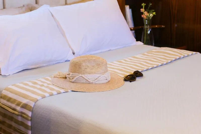 New School Yacht Photos Pics Cozy bed with straw hat and sunglasses on Chris-Craft Constellation, 1966.