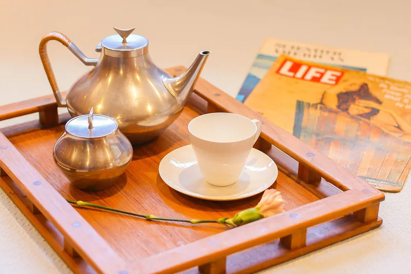 New School Yacht Photos Pics Vintage tea set on wooden tray with Life magazine, evoking 1960s nostalgia.