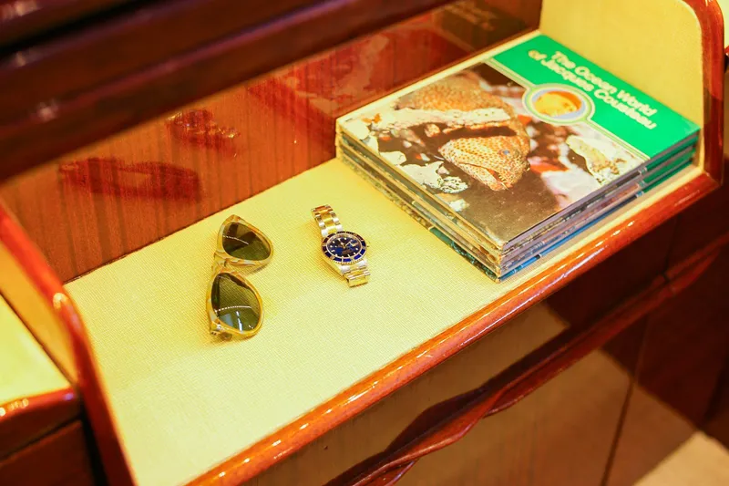 New School Yacht Photos Pics Vintage Chris-Craft Constellation 1966 interior with sunglasses, watch, and marine life books.