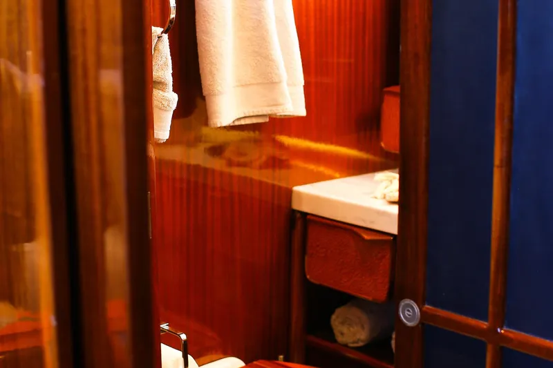 New School Yacht Photos Pics Interior of 1966 Chris-Craft Constellation yacht with wooden paneling and towels.