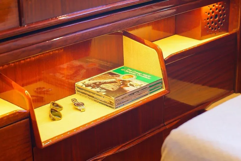 New School Yacht Photos Pics Luxurious 1966 Chris-Craft Constellation interior with magazines, sunglasses, and a watch on display.