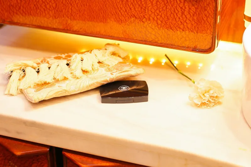 New School Yacht Photos Pics Elegant vanity setup on 1966 Chris-Craft Constellation with makeup, floral pouch, and carnation.