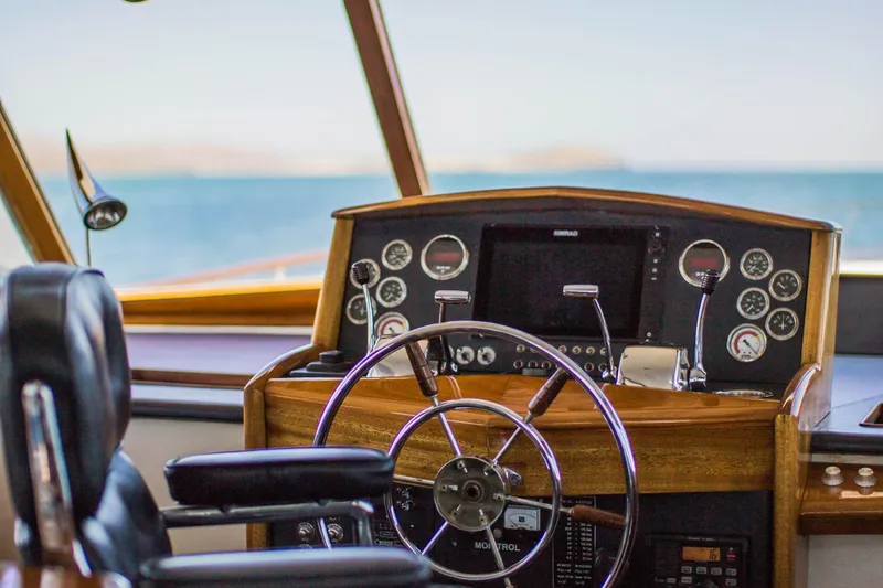 New School Yacht Photos Pics 1966 Chris-Craft Constellation helm with classic wooden dashboard and steering wheel.