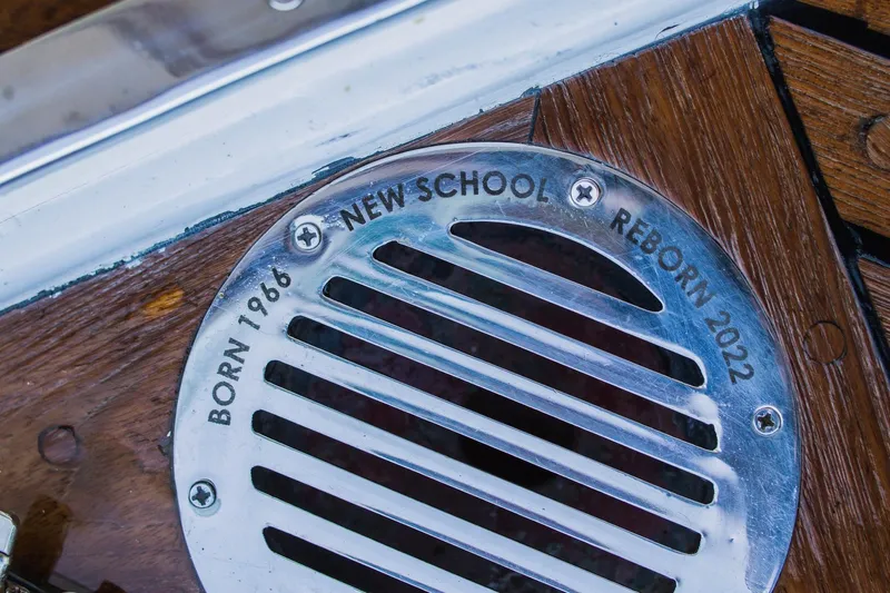 New School Yacht Photos Pics 1966 Chris-Craft Constellation detail, "Born 1966, Reborn 2022" inscription on metal vent.