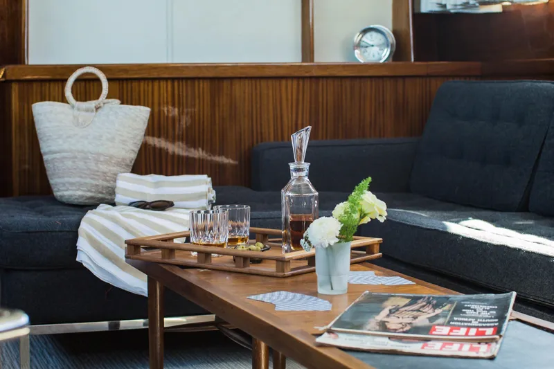 New School Yacht Photos Pics Luxurious 1966 Chris-Craft Constellation yacht interior with elegant decor and vintage magazines.