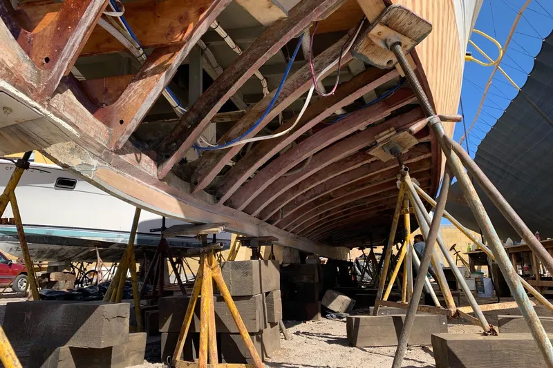 New School Yacht Photos Pics 1966 Chris-Craft Constellation under restoration, supported by stands and blocks.