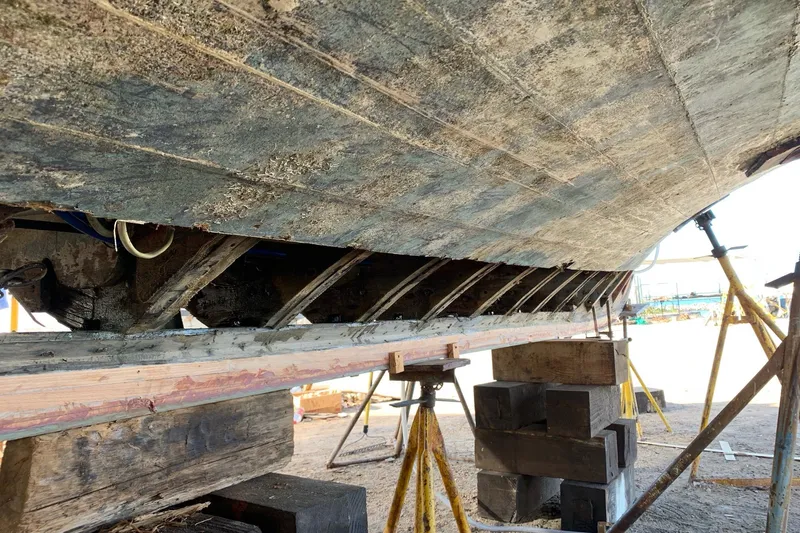 New School Yacht Photos Pics 1966 Chris-Craft Constellation boat hull under restoration, supported by blocks and stands.