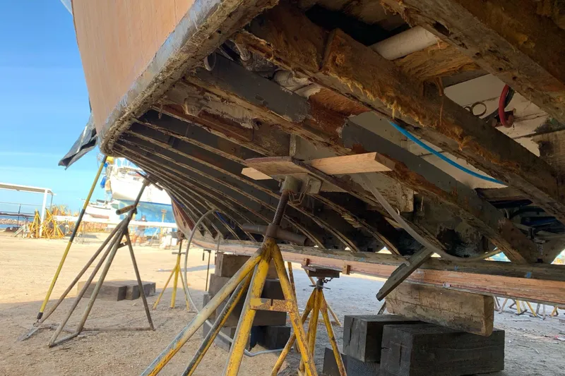 New School Yacht Photos Pics 1966 Chris-Craft Constellation under restoration, supported by stands, showing hull structure.