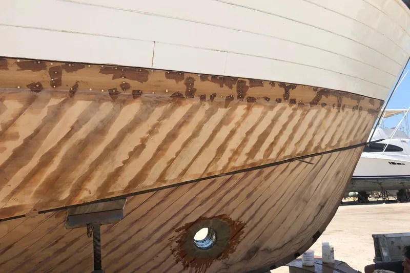 New School Yacht Photos Pics 1966 Chris-Craft Constellation boat hull under restoration, showcasing wooden craftsmanship.