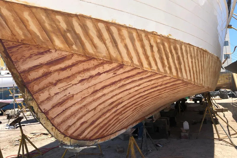 New School Yacht Photos Pics 1966 Chris-Craft Constellation boat hull under restoration, showcasing wooden craftsmanship.