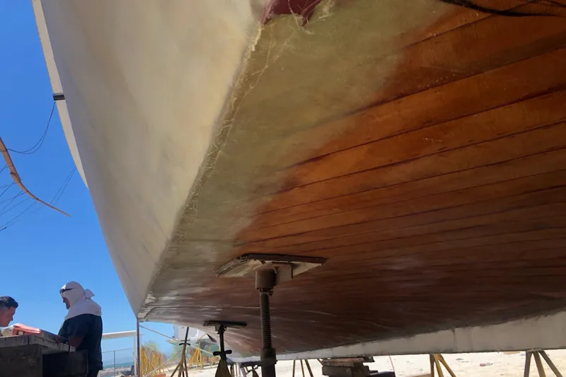 New School Yacht Photos Pics 1966 Chris-Craft Constellation boat under restoration, showcasing wooden hull and fiberglass work.