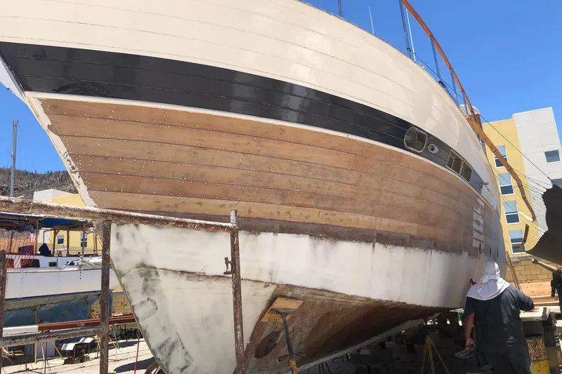 New School Yacht Photos Pics 1966 Chris-Craft Constellation boat under restoration, showcasing wooden hull and classic design.