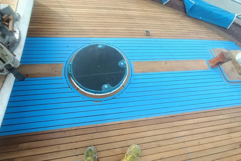 New School Yacht Photos Pics 1966 Chris-Craft Constellation deck with blue accents and circular hatch.