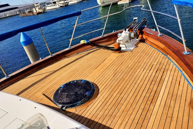 New School Yacht Photos Pics 1966 Chris-Craft Constellation boat deck with wooden finish, docked at marina.