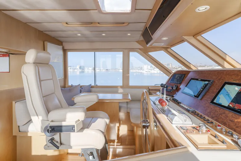 Artemis Yacht Photos Pics 1996 Offshore Yachts Pilothouse interior with helm, navigation screens, and panoramic windows.
