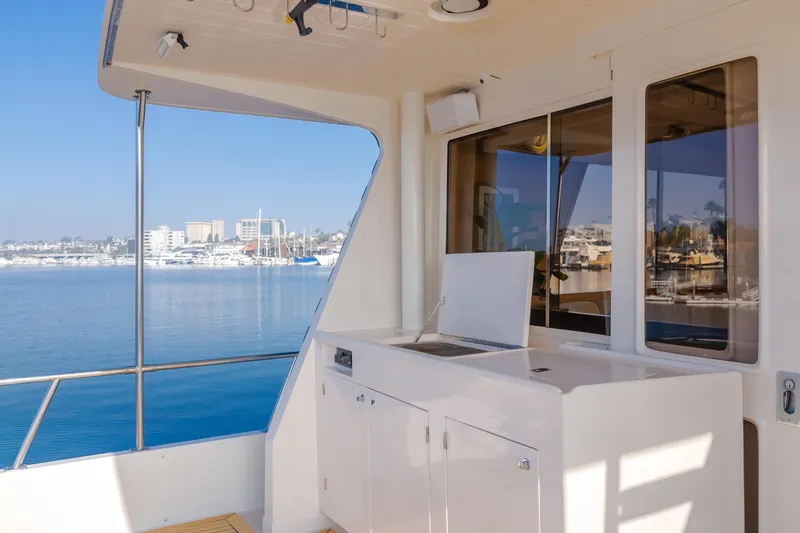 Artemis Yacht Photos Pics 1996 Offshore Yachts Pilothouse with ocean view, featuring sleek white exterior and spacious deck area.