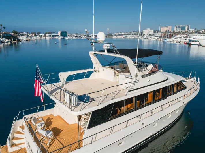 Artemis Yacht Photos Pics 1996 Offshore Yachts Pilothouse in marina, featuring spacious deck and elegant design.