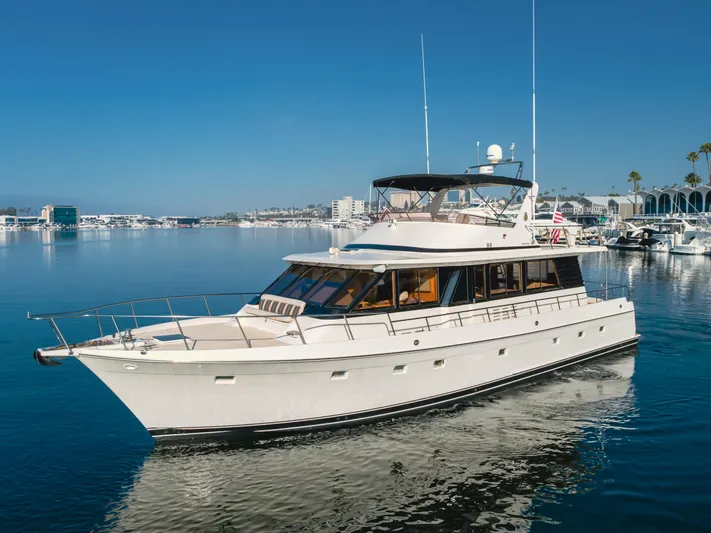 Artemis Yacht Photos Pics 1996 Offshore Yachts Pilothouse cruising in a serene marina setting.