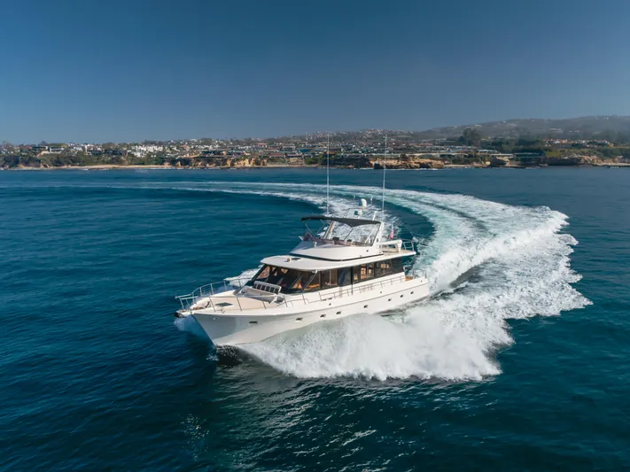 Artemis Yacht Photos Pics 1996 Offshore Yachts Pilothouse cruising on open water, creating a dynamic wake.