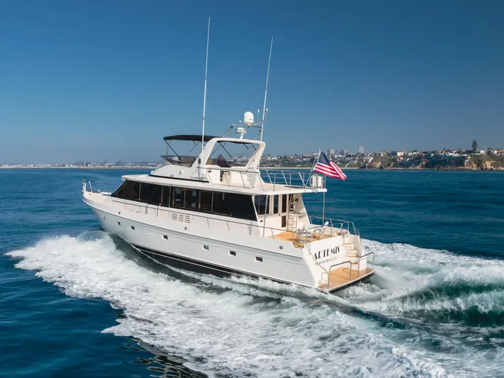 Artemis Yacht Photos Pics Offshore Yachts 1996 Pilothouse cruising on open water, American flag waving.