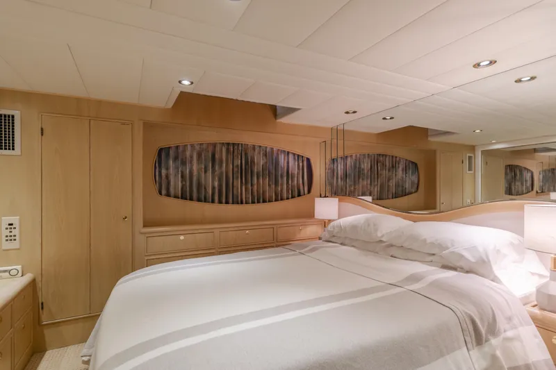 Artemis Yacht Photos Pics Luxurious bedroom interior of 1996 Offshore Yachts Pilothouse, featuring elegant wood paneling.