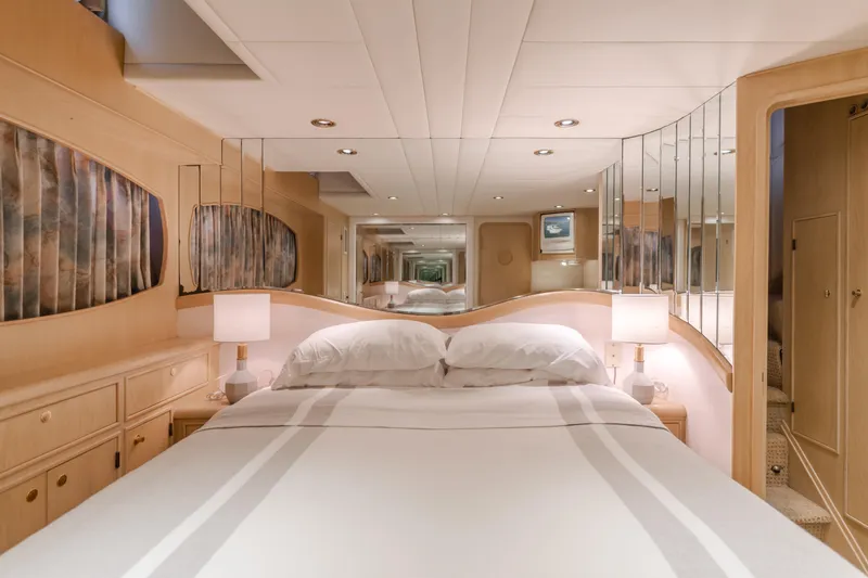 Artemis Yacht Photos Pics Luxurious bedroom interior of a 1996 Offshore Yachts Pilothouse, featuring elegant decor and ambient lighting.