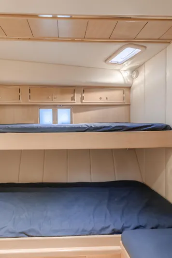 Artemis Yacht Photos Pics 1996 Offshore Yachts Pilothouse interior with bunk beds and wooden cabinetry.