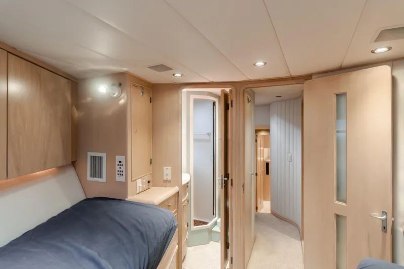 Artemis Yacht Photos Pics Interior of 1996 Offshore Yachts Pilothouse, featuring cozy cabin with bed and modern lighting.